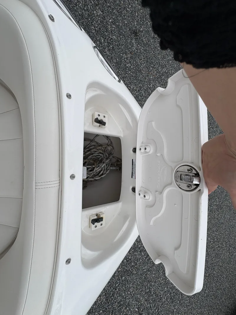 Slide: The Image of 2009 Chaparral 210 SSi boat storage compartment with open lid, revealing interior space. - 22