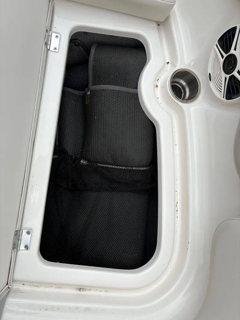 Slide: The Image of Storage compartment in 2009 Chaparral 210 SSi boat with speaker and cup holder. - 25