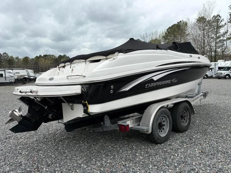 Slide: The Image of 2009 Chaparral 210 SSi boat on trailer, covered, parked on gravel lot. - 3