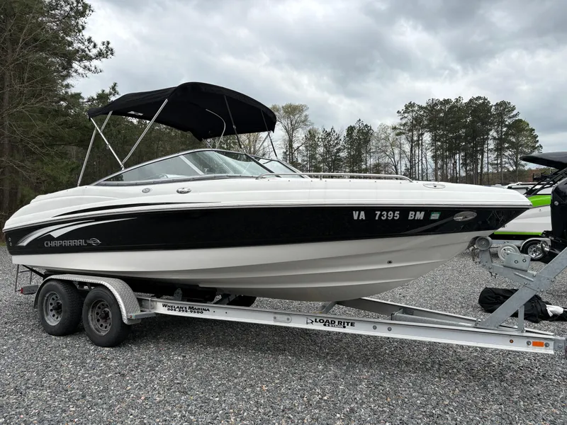 Slide: The Image of 2009 Chaparral 210 SSi boat on trailer, black and white design, parked outdoors. - 30