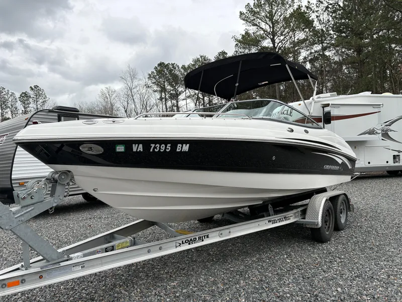 Slide: The Image of 2009 Chaparral 210 SSi boat on trailer, parked outdoors with overcast sky. - 32
