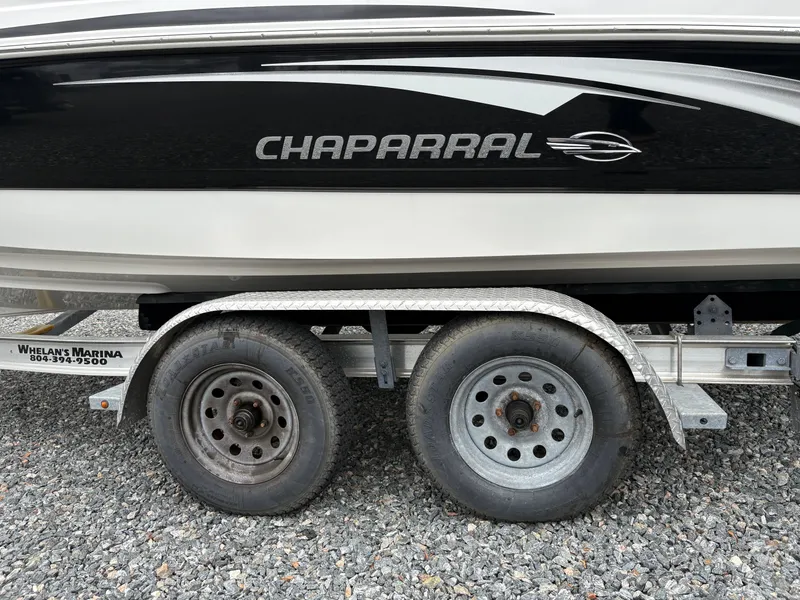 Slide: The Image of 2009 Chaparral 210 SSi boat on trailer with dual wheels, gravel background. - 6