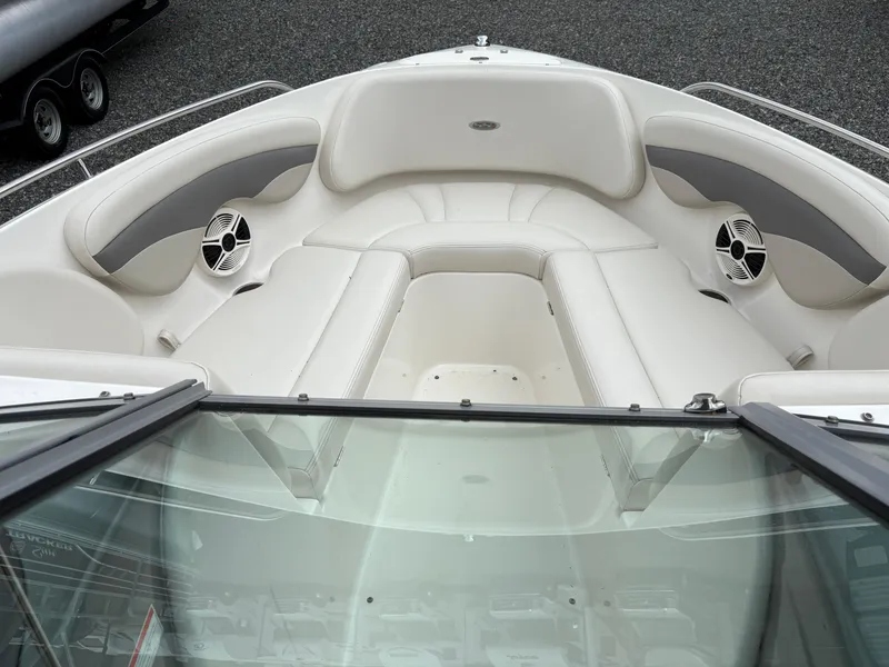 Slide: The Image of 2009 Chaparral 210 SSi boat interior with white seating and speakers. - 7