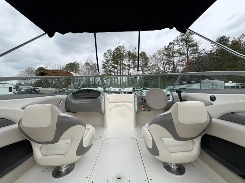 Slide: The Image of 2009 Chaparral 210 SSi boat interior with two seats and steering console. - 8