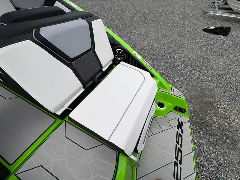 Slide: The Image of 2022 Yamaha Boats 255XD with sleek green and white seating on a textured deck. - 12