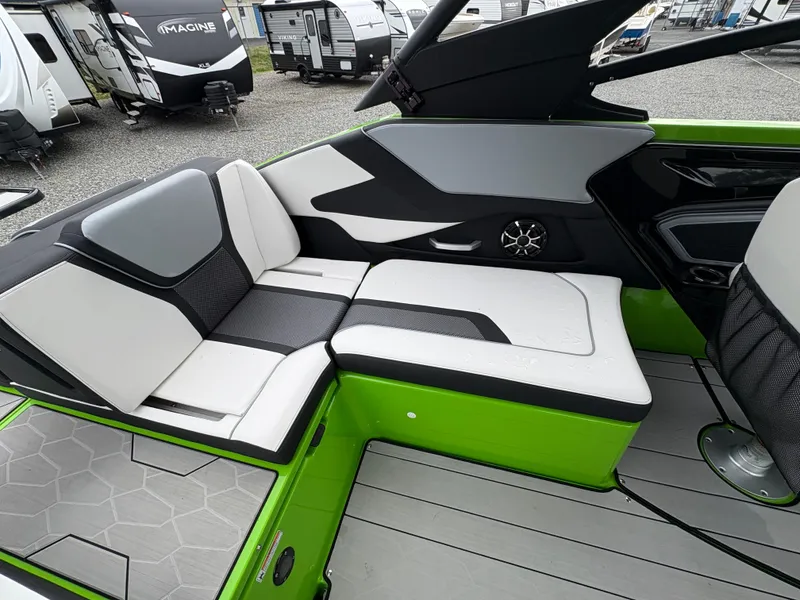 Slide: The Image of 2022 Yamaha Boats 255XD interior with green accents and modern seating design. - 14