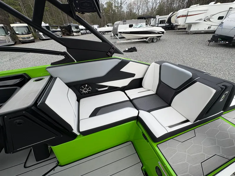 Slide: The Image of 2022 Yamaha Boats 255XD interior with sleek seating and modern design in a vibrant green finish. - 15