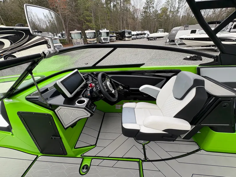 Slide: The Image of 2022 Yamaha Boats 255XD cockpit with green accents and modern dashboard. - 16