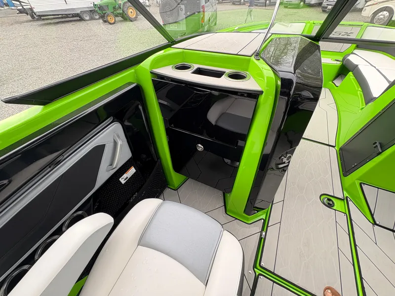 Slide: The Image of 2022 Yamaha Boats 255XD interior with vibrant green accents and modern seating. - 18