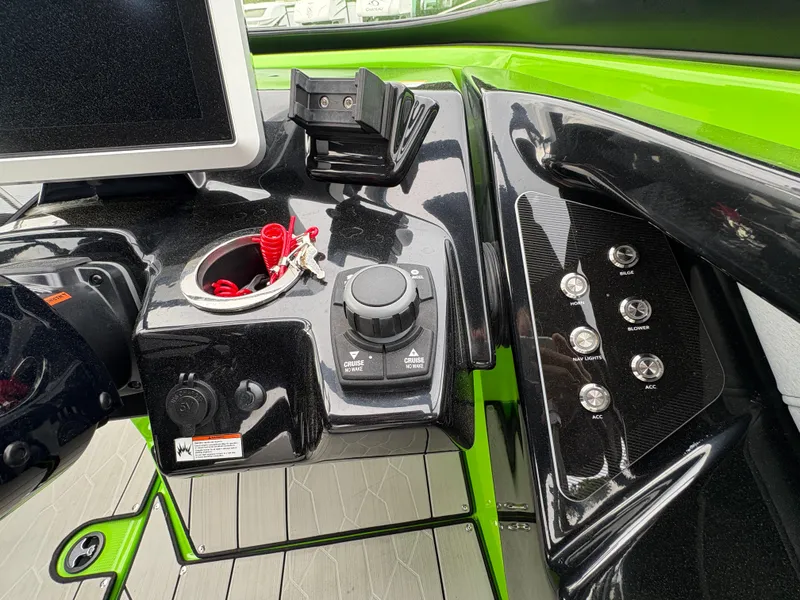 Slide: The Image of Control panel of a 2022 Yamaha Boats 255XD, featuring sleek black and green design. - 20