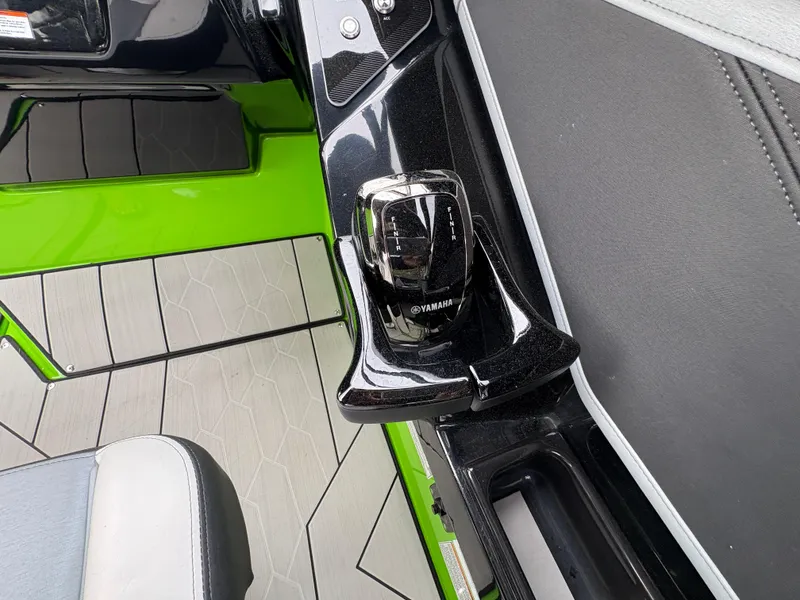 Slide: The Image of Yamaha Boats 2022 255XD interior with sleek black and green design, featuring modern controls. - 21