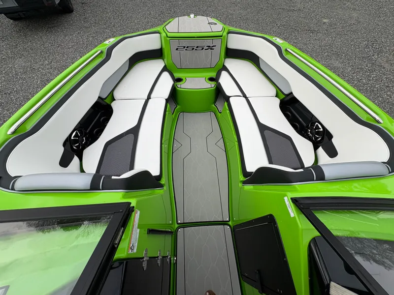 Slide: The Image of 2022 Yamaha Boats 255XD interior, green and white seating, modern design. - 22