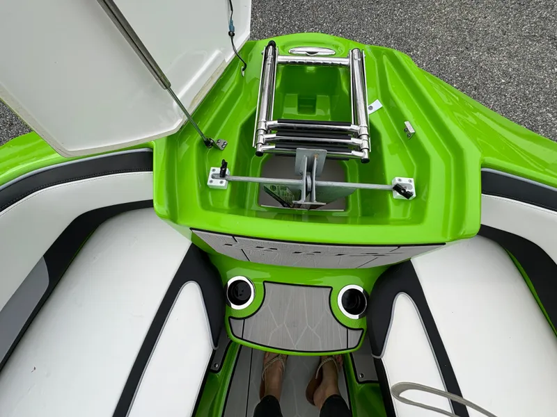 Slide: The Image of 2022 Yamaha Boats 255XD, vibrant green deck with seating and ladder. - 26