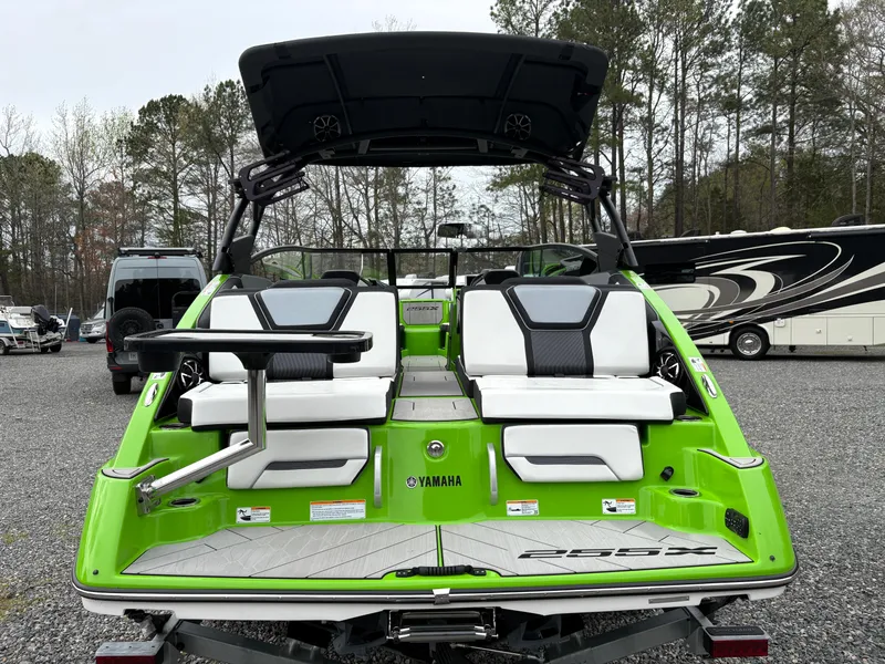 Slide: The Image of 2022 Yamaha Boats 255XD in vibrant green, rear view with seating and swim platform. - 3