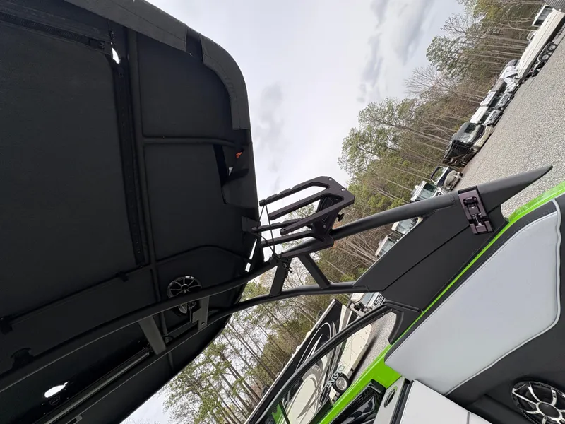 Slide: The Image of 2022 Yamaha Boats 255XD with sleek design, featuring a modern canopy and vibrant green accents. - 34