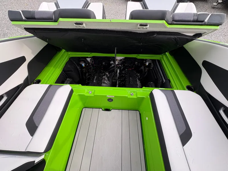 Slide: The Image of 2022 Yamaha Boats 255XD engine compartment with open hatch, showcasing sleek design and seating. - 36
