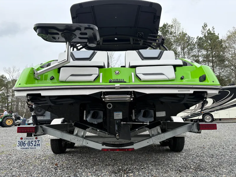 Slide: The Image of 2022 Yamaha Boats 255XD in vibrant green on a trailer, rear view. - 4