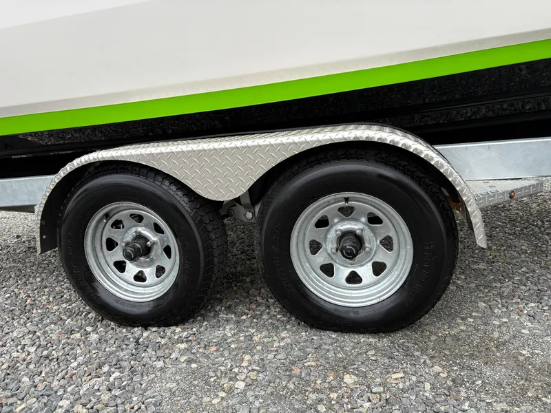 Slide: The Image of Trailer wheels of a 2022 Yamaha Boats 255XD on gravel surface. - 7