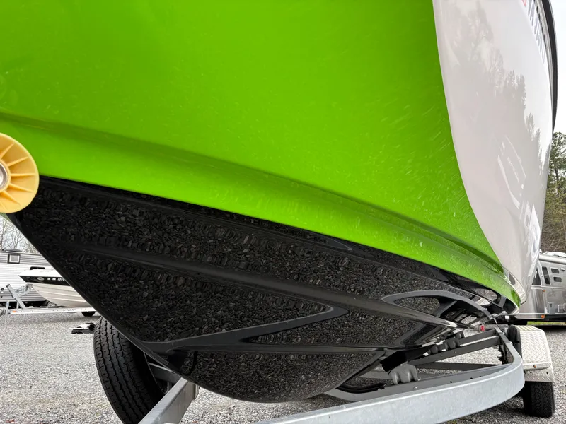 Slide: The Image of 2022 Yamaha Boats 255XD with vibrant green hull on a trailer. - 9