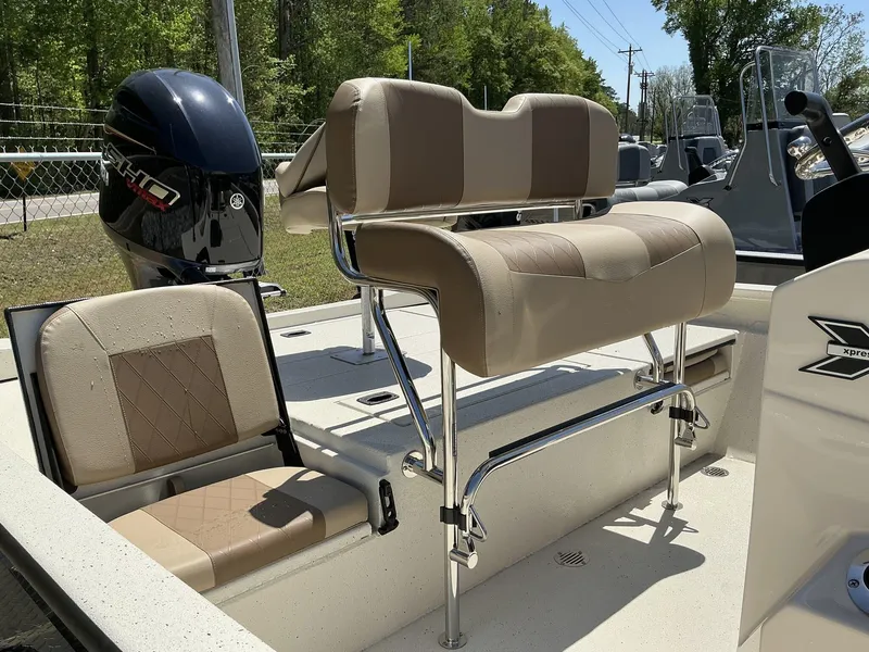 Slide: The Image of 2025 Xpress Hyper-Lift Series H22B boat interior with comfortable seating and Yamaha engine. - 5