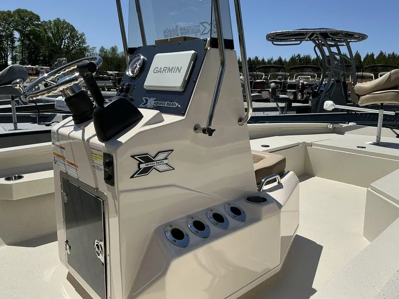 Slide: The Image of 2025 Xpress Hyper-Lift Series H22B boat console with Garmin system and steering wheel. - 7