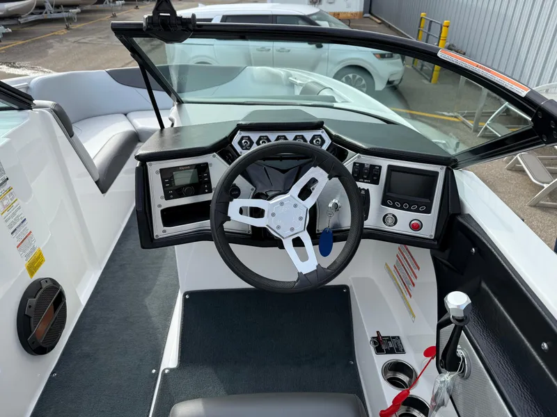 Slide: The Image of 2019 MasterCraft NXT22 boat dashboard with steering wheel and control panel. - 10