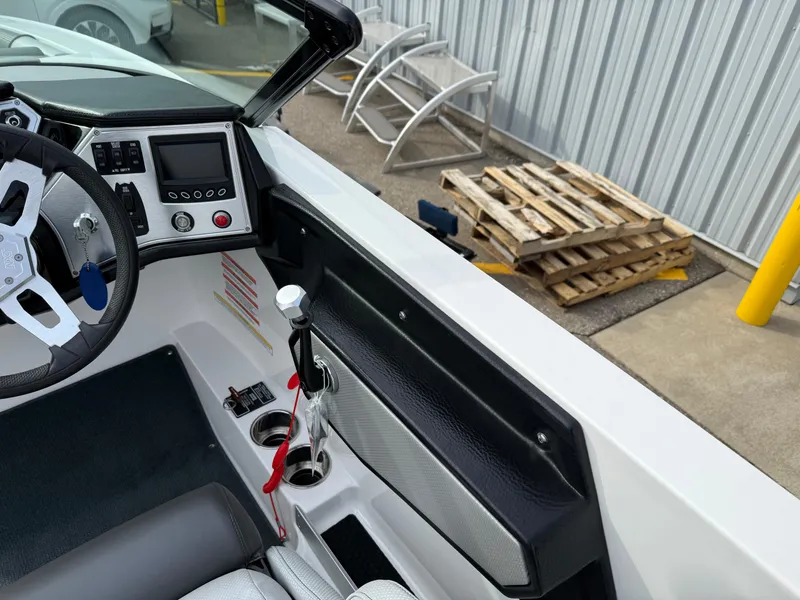 Slide: The Image of 2019 MasterCraft NXT22 boat interior with steering wheel and control panel. - 11