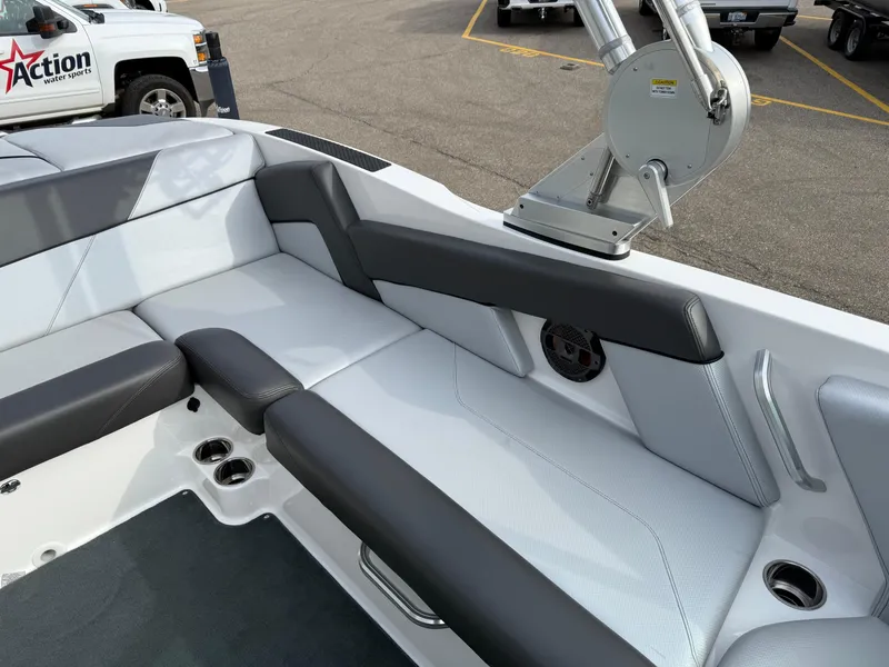 Slide: The Image of 2019 MasterCraft NXT22 boat interior with gray seating and cup holders. - 13