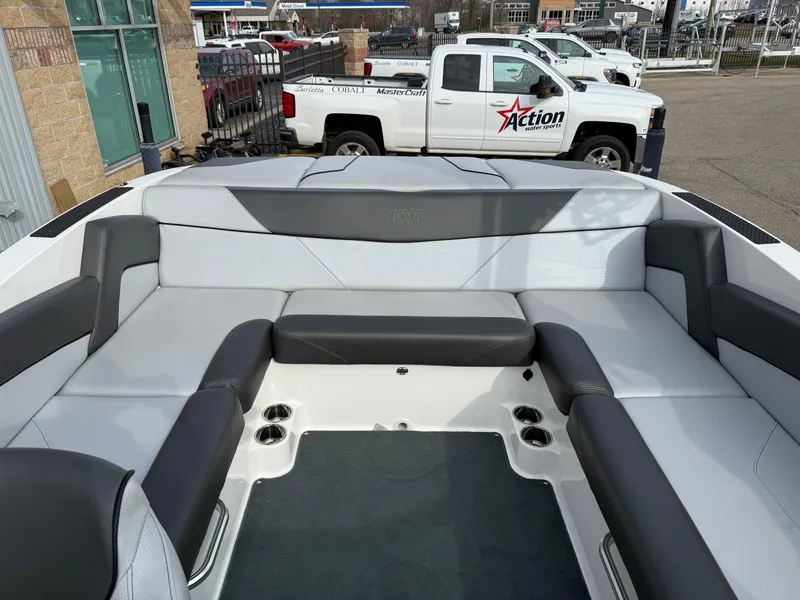 Slide: The Image of 2019 MasterCraft NXT22 boat interior with gray seating and cup holders. - 14