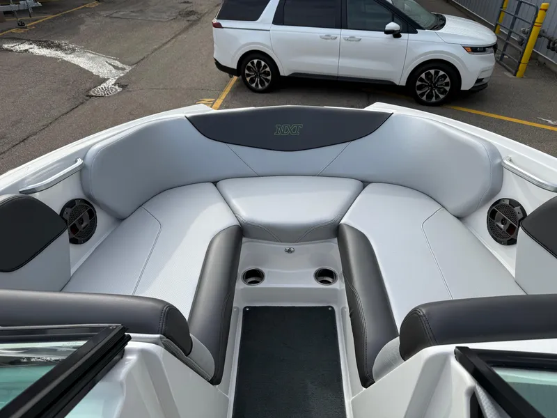 Slide: The Image of 2019 MasterCraft NXT22 boat interior with gray seating and cup holders. - 16