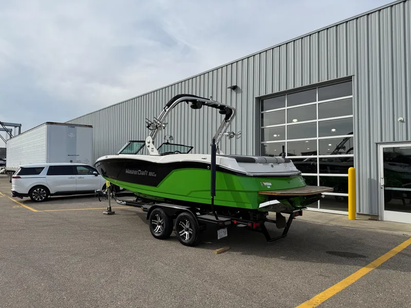 Slide: The Image of 2019 MasterCraft NXT22 boat in vibrant green on trailer outside dealership. - 3