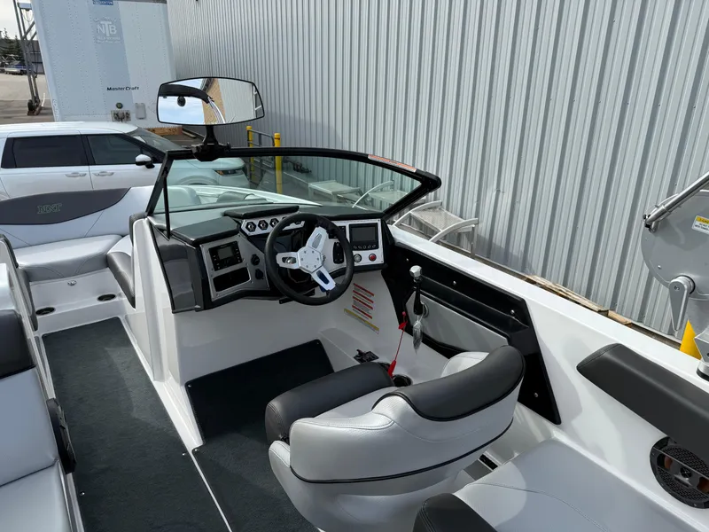 Slide: The Image of 2019 MasterCraft NXT22 boat interior with steering wheel and dashboard controls. - 9