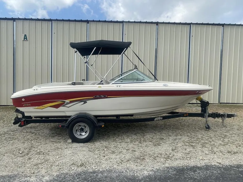 Slide: The Image of 2003 Sea Ray 182 SRX Bow Rider boat on trailer, parked outdoors. - 1