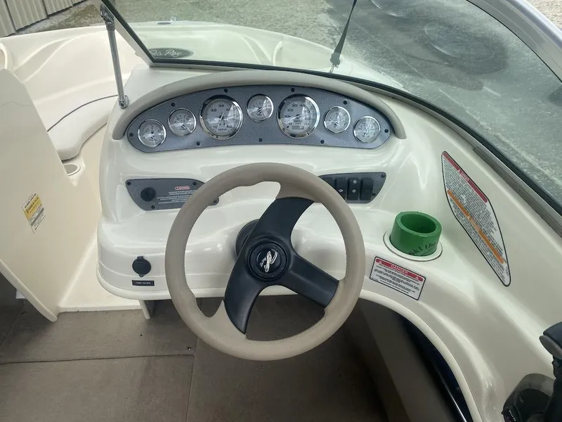 Slide: The Image of 2003 Sea Ray 182 SRX Bow Rider dashboard with steering wheel and gauges. - 10
