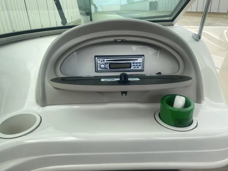 Slide: The Image of 2003 Sea Ray 182 SRX Bow Rider dashboard with stereo and cup holders. - 11