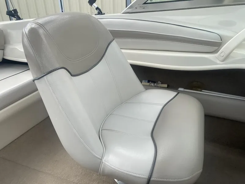 Slide: The Image of 2003 Sea Ray 182 SRX Bow Rider interior with white and gray seating. - 13