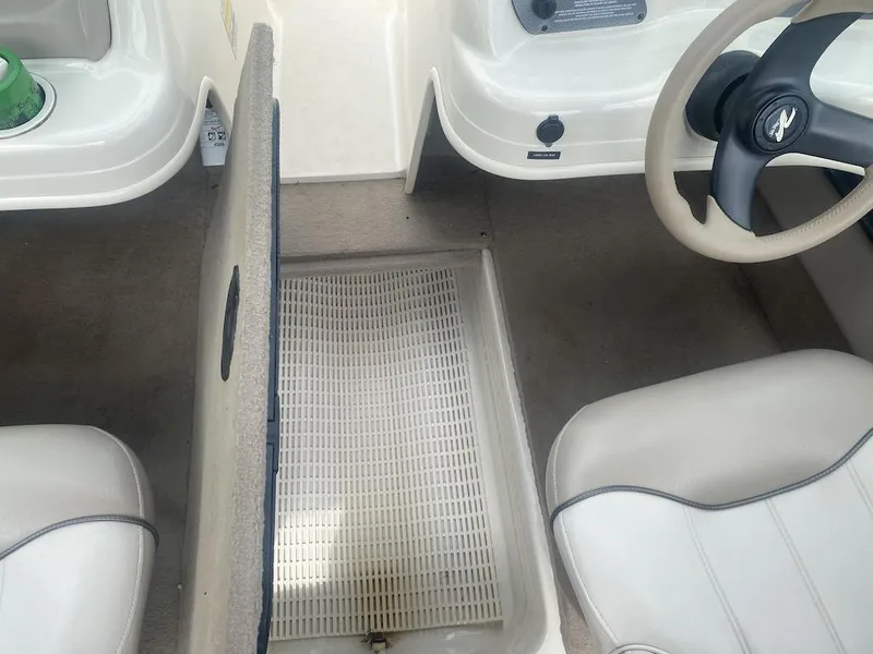 Slide: The Image of Interior of 2003 Sea Ray 182 SRX Bow Rider boat showing seating and steering wheel. - 15