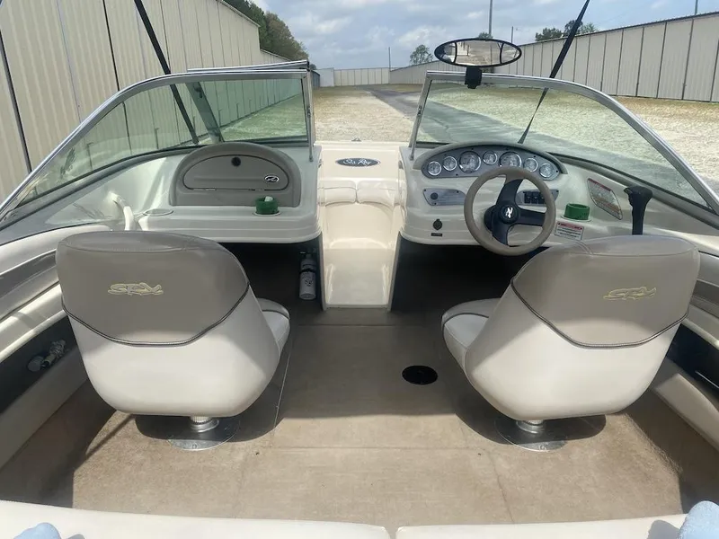 Slide: The Image of 2003 Sea Ray 182 SRX Bow Rider interior with dual seats and dashboard view. - 19
