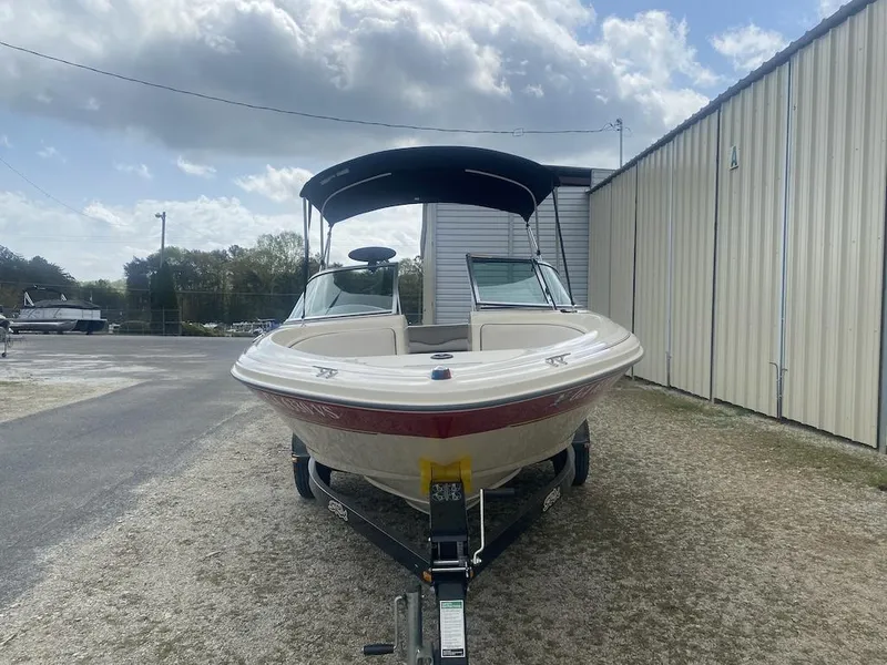 Slide: The Image of 2003 Sea Ray 182 SRX Bow Rider boat on trailer, parked outdoors. - 2
