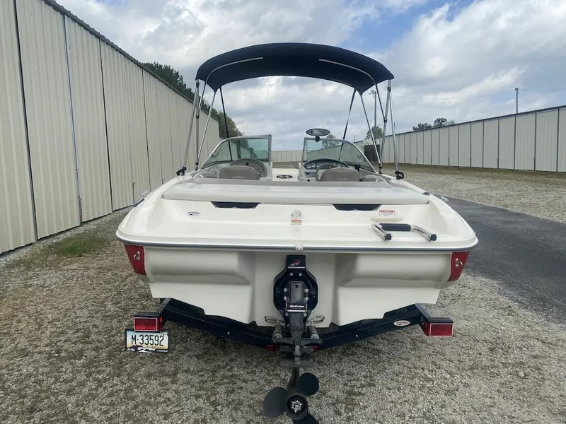 Slide: The Image of 2003 Sea Ray 182 SRX Bow Rider boat with canopy, parked outdoors. - 4