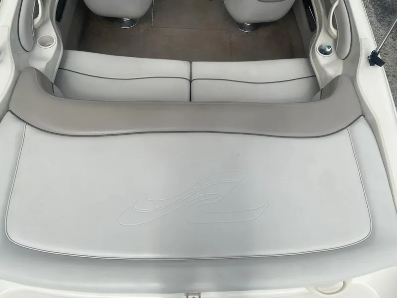 Slide: The Image of 2003 Sea Ray 182 SRX Bow Rider interior with gray seating and cup holders. - 5
