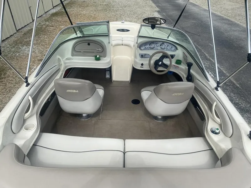 Slide: The Image of 2003 Sea Ray 182 SRX Bow Rider interior with steering wheel and seating. - 6