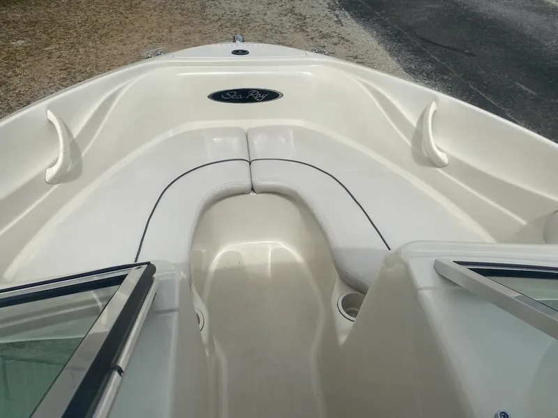 Slide: The Image of 2003 Sea Ray 182 SRX Bow Rider interior with white seating and cup holders. - 7