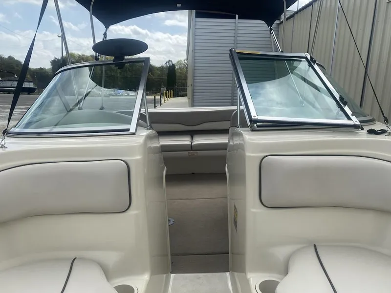 Slide: The Image of 2003 Sea Ray 182 SRX Bow Rider interior with open windshield and seating area. - 9