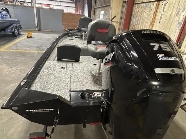Slide: The Image of 2025 Tracker PT175TF boat with Mercury 75 engine in a warehouse setting. - 3