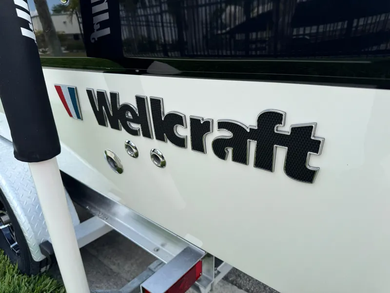 Slide: The Image of 2016 Wellcraft 241 boat logo on white hull, close-up view. - 18
