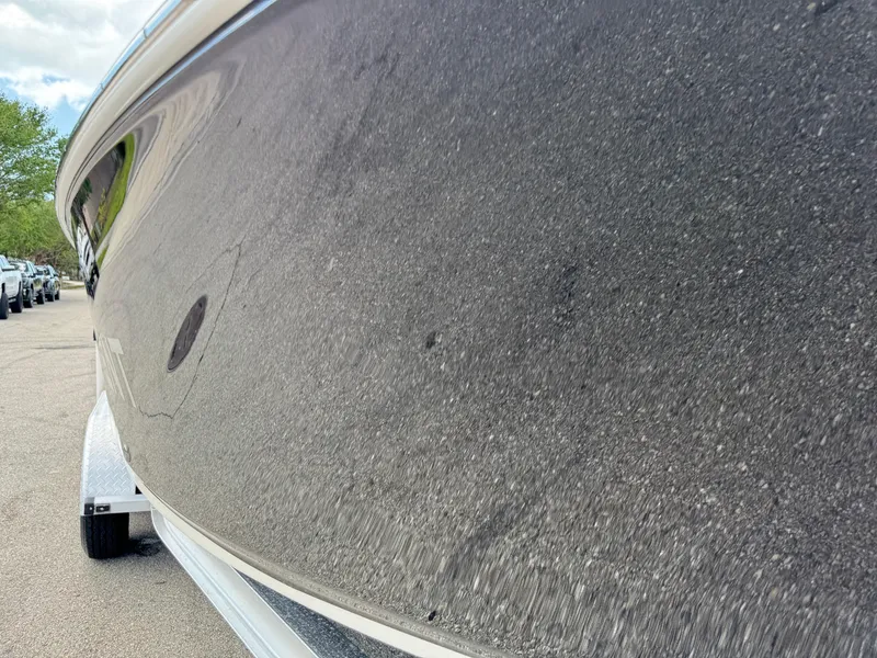 Slide: The Image of 2016 Wellcraft 241 boat hull close-up, showcasing sleek design and smooth finish. - 21