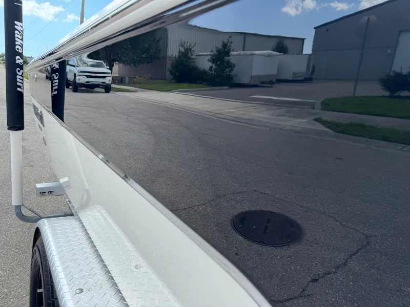 Slide: The Image of 2016 Wellcraft 241 boat on trailer, reflecting street and buildings. - 23