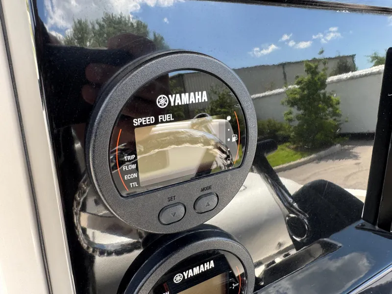 Slide: The Image of Yamaha speed fuel gauge on 2016 Wellcraft 241 boat dashboard, reflecting outdoor scenery. - 29
