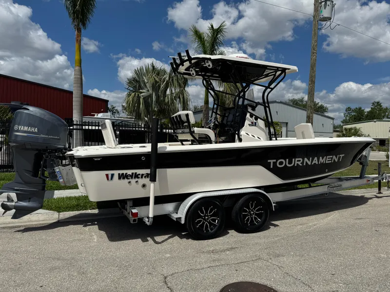 Slide: The Image of 2016 Wellcraft 241 boat on trailer, Yamaha engine, parked outdoors under blue sky. - 3